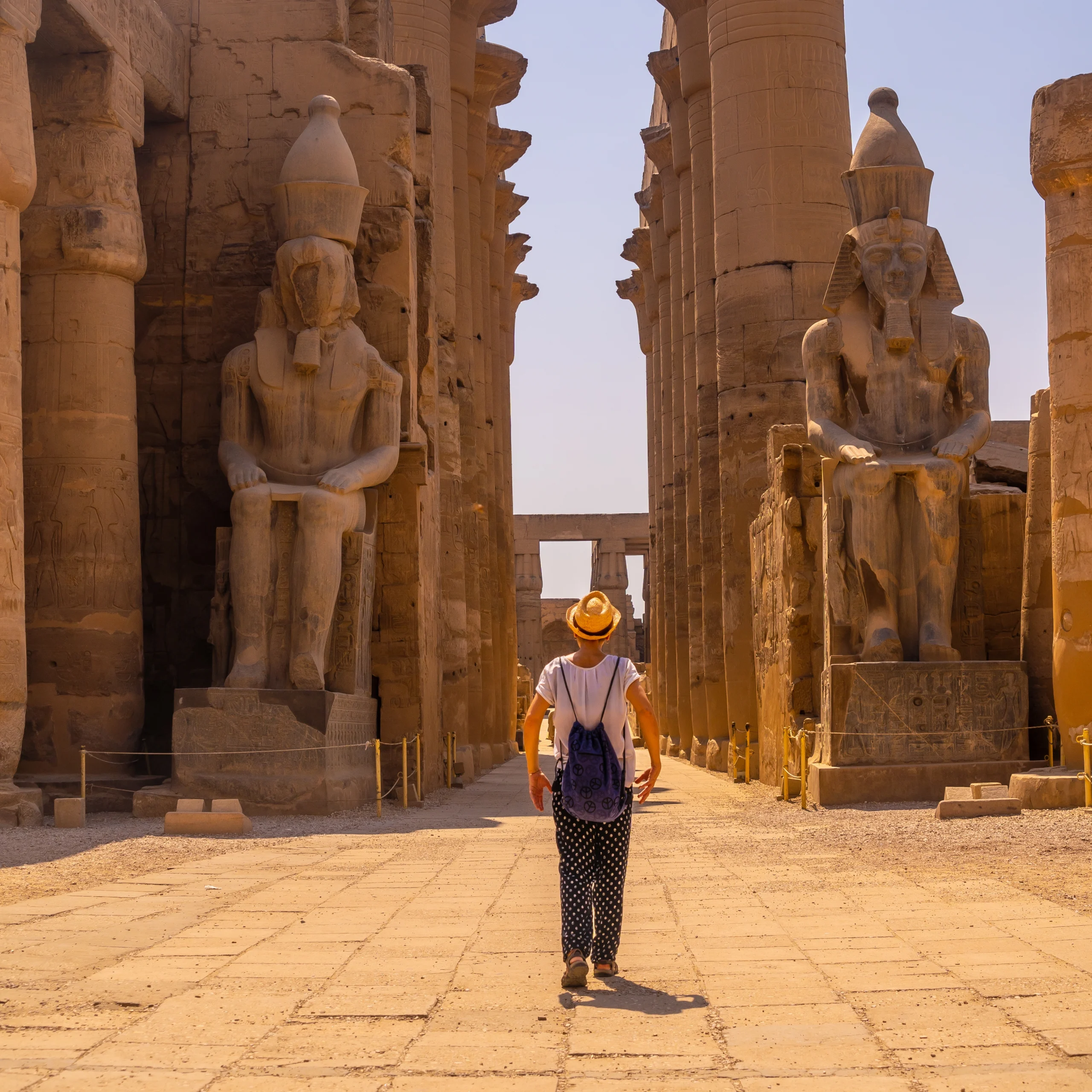 woman-with-hat-visiting-egyptian-temple-luxor-its-beautiful-columns-egypt woman-with-hat-visiting-egyptian-temple-luxor-its-beautiful-columns-egypt